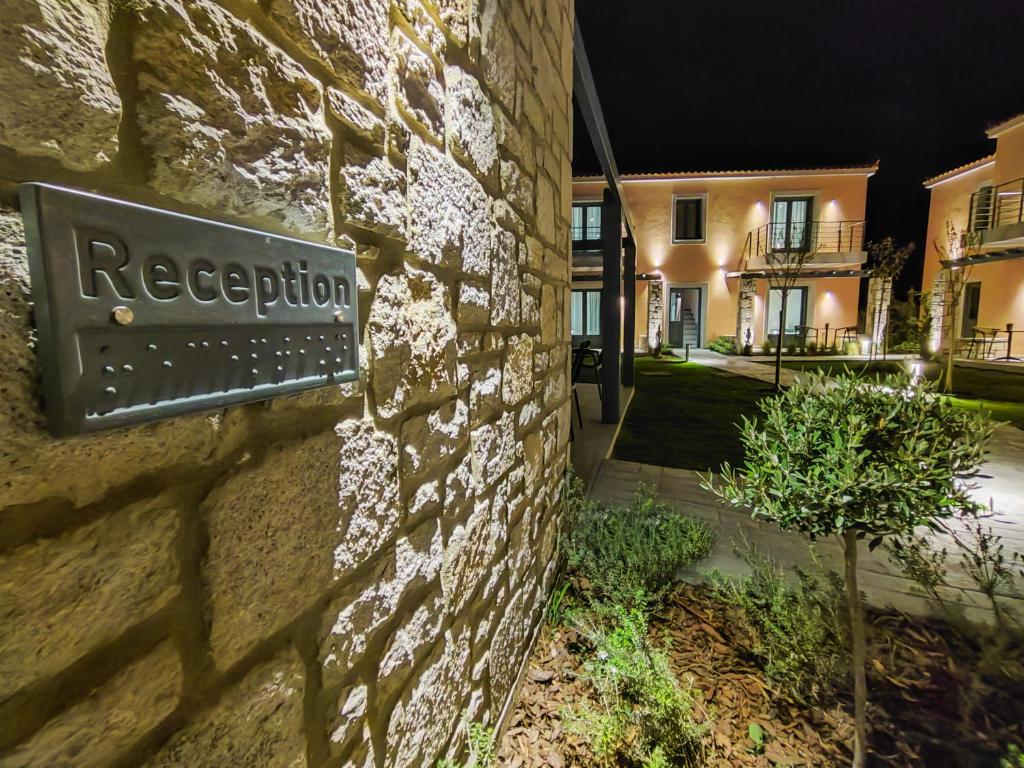 a sign on the side of a stone building at Nissos Apartments in Myrina
