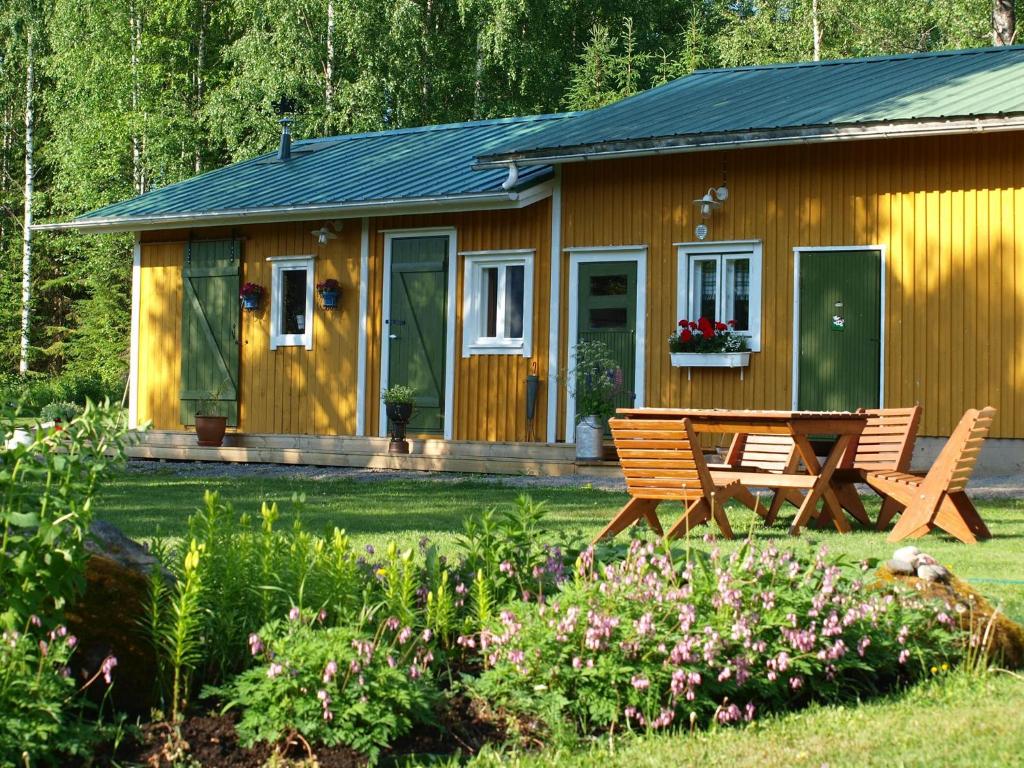 eine Holzhütte mit einem Picknicktisch davor in der Unterkunft Suopirtti bed & breakfast in Konnevesi