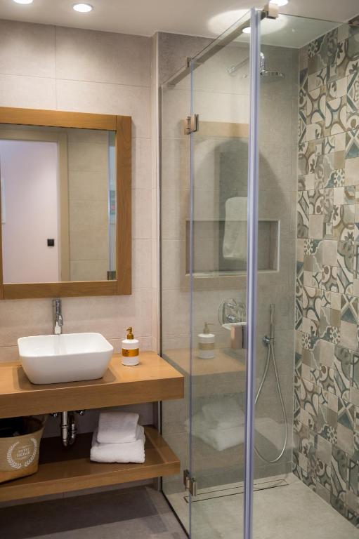 a bathroom with a sink and a shower at Nissos Apartments in Myrina