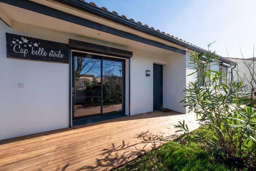 une devanture de magasin avec une grande vitrine sur une terrasse en bois dans l'établissement cap belle étoile, à La Rochelle