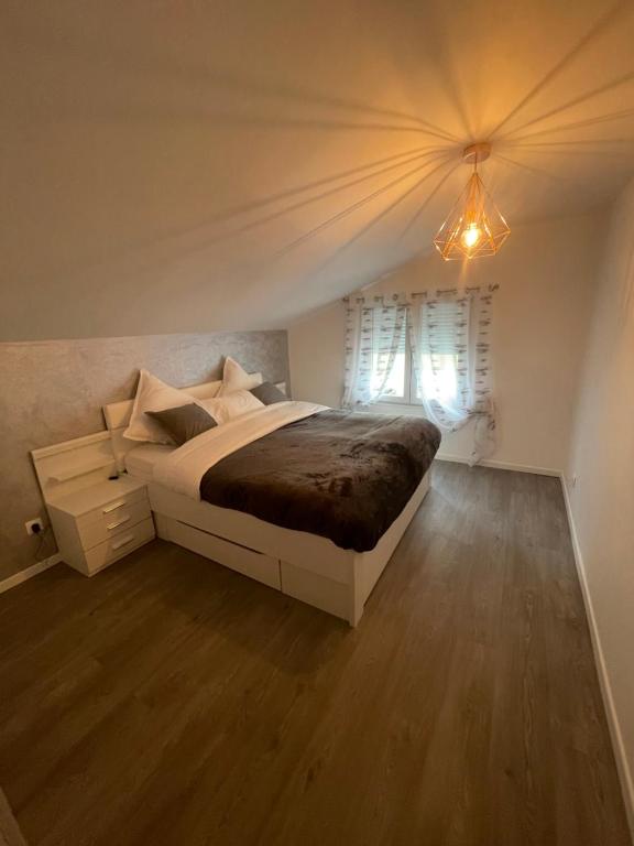 a bedroom with a large bed and a window at Maisonnette avec terrasse in Strasbourg