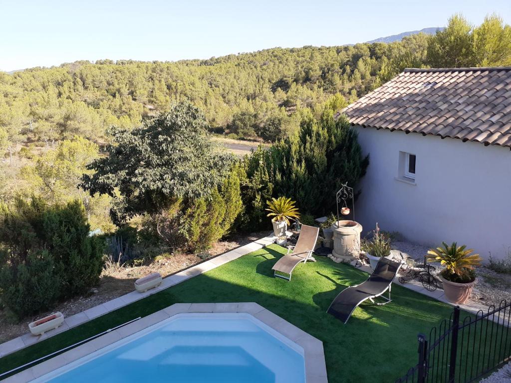 a backyard with a swimming pool and a house at La plaine in Saint-Clément-de-Rivière