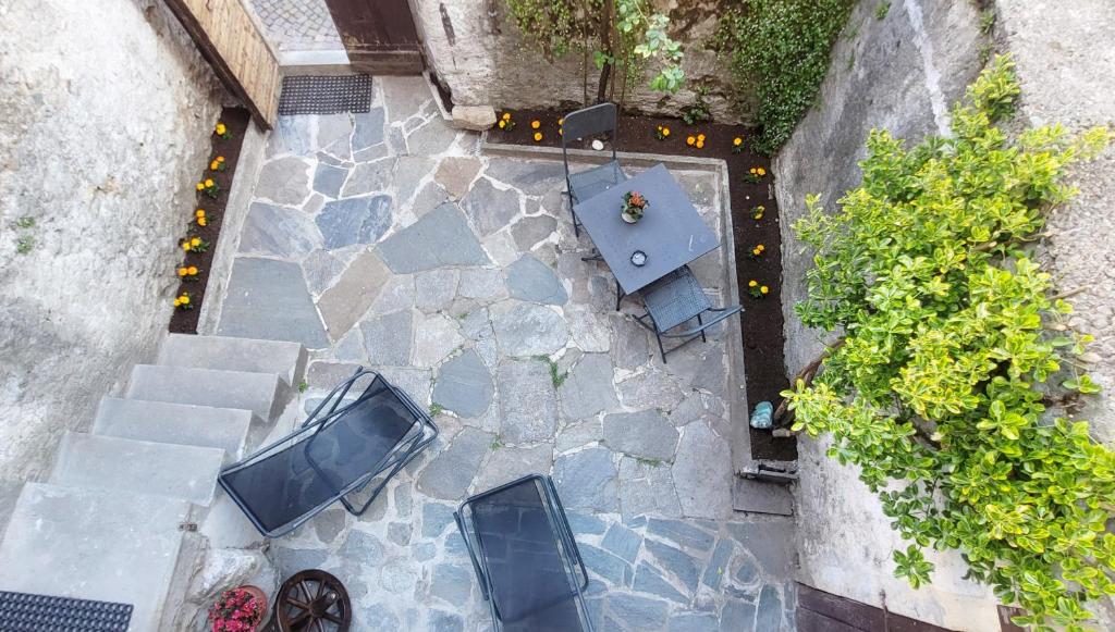 an overhead view of a patio with a table and chairs at Charming traditional mountain house in Taceno