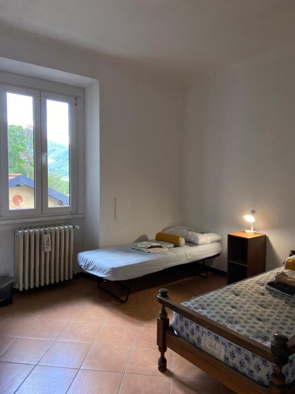 a room with two beds and a window at Villa Virginia in Varese