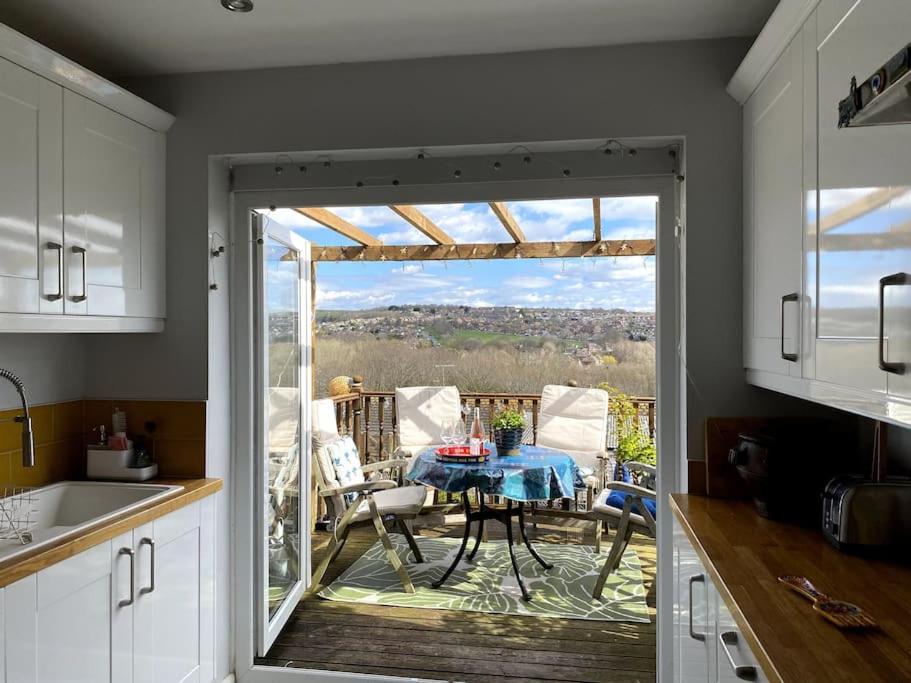 a kitchen with a table and a view of a patio at Gateway to the South Downs Near Brighton in Portslade