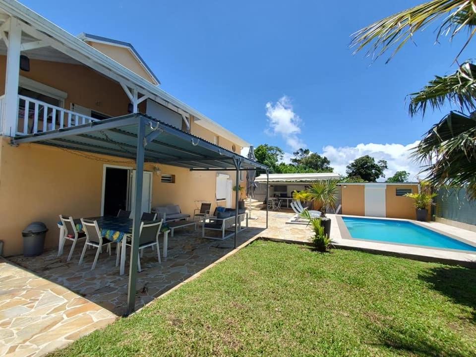 a house with a patio and a swimming pool at Villa bassin bleu in Gourbeyre