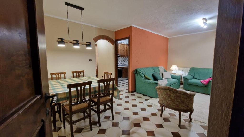 a living room and dining room with a table and chairs at Casa Sole in Morgex
