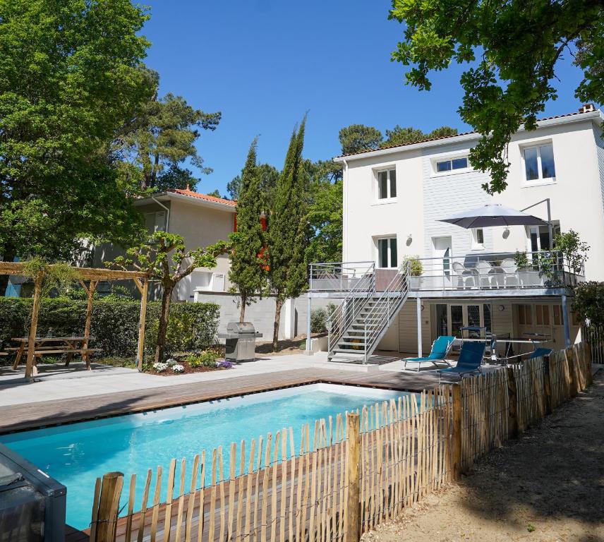 a swimming pool in front of a house at La Casita - Ronce les bains in La Tremblade