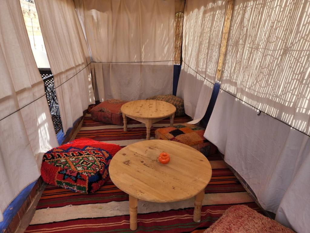 a inside of a tent with two tables and couches at RIAD GALIYA in Marrakech