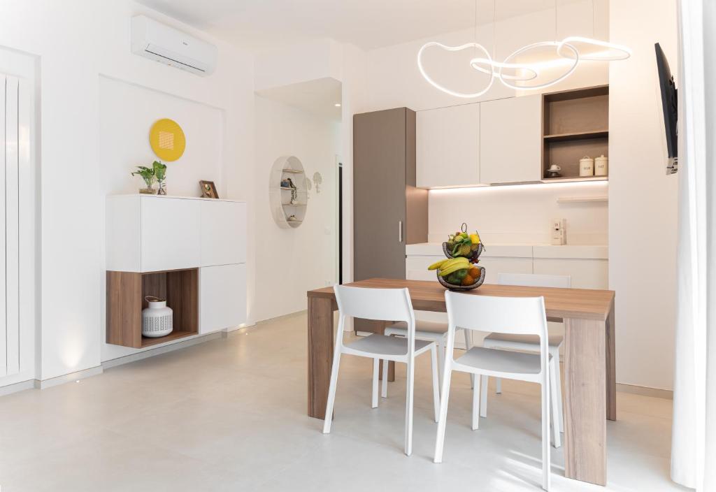 a kitchen and dining room with a wooden table and chairs at Il Mama House in Termoli