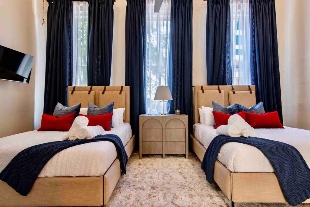 a bedroom with two beds with red and blue pillows at *New* Bourbon City Luxury Guest House in Louisville