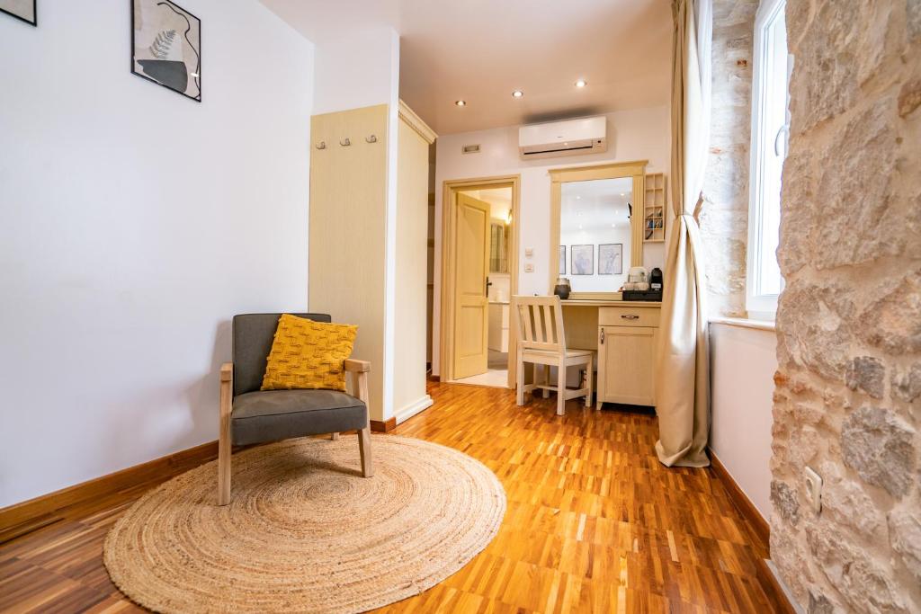 a living room with a chair and a kitchen at Luxury Rooms Lucija and Luka in Split
