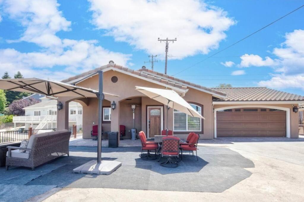 a house with a patio with a table and chairs at Hillside view with hot tub too in Arroyo Grande