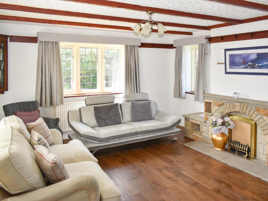 a living room with two couches and a fireplace at Albion Cottage in Whitby