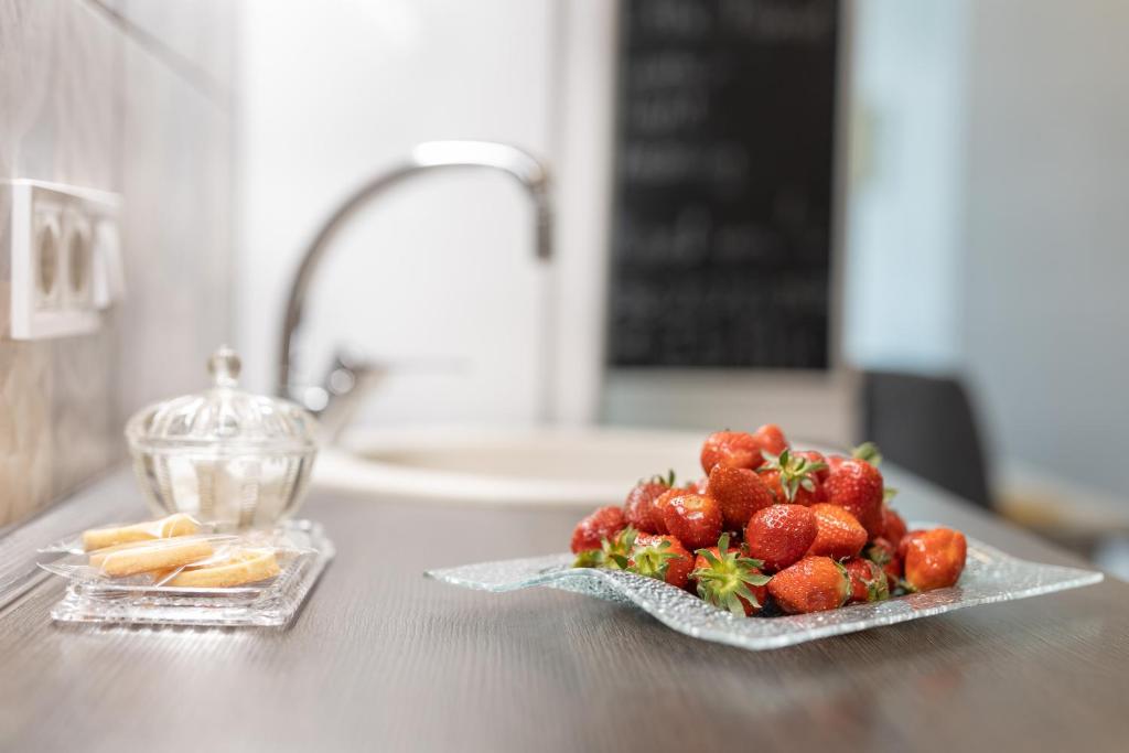 Hotel Margit Apartment, a plate of strawberries on a counter next to a sink at Margit Apartment in Budapest