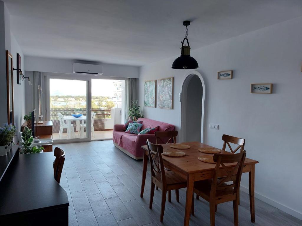 a living room with a table and a couch at Family Relax Apartment in Alcudia