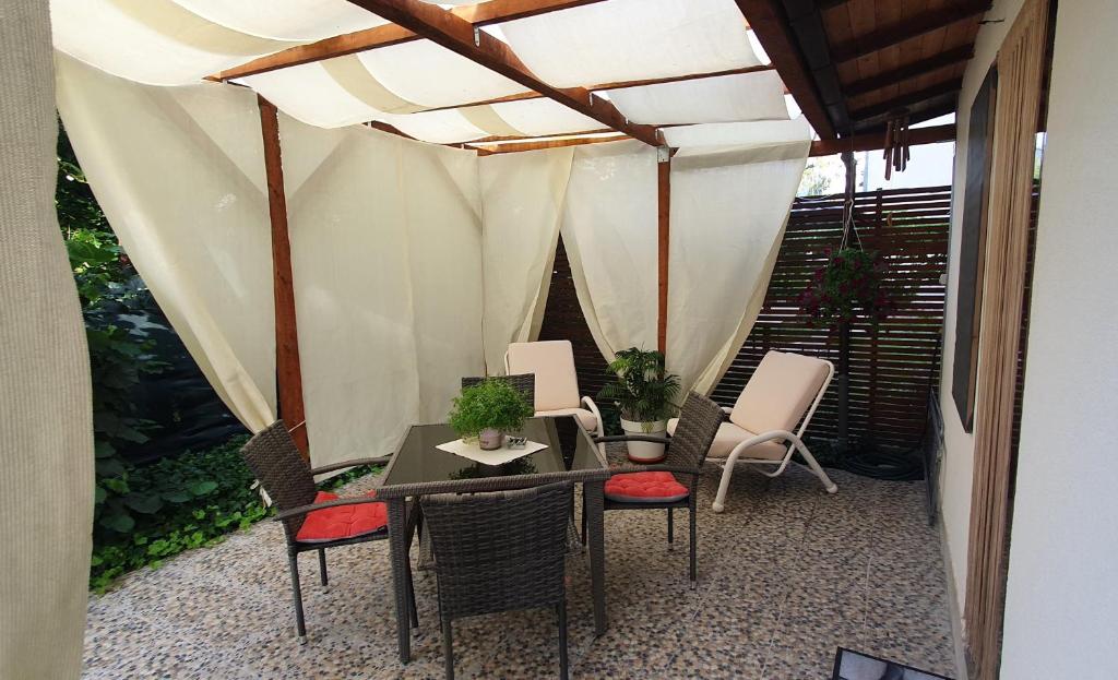 een patio met een tafel en stoelen en een tent bij D&A Apartment in Ohrid