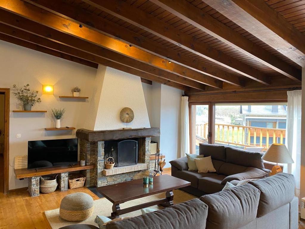 a living room with a couch and a fireplace at Ático en Llivia in Llivia