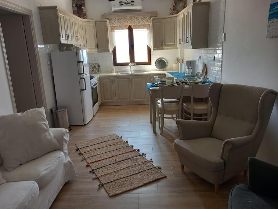 a kitchen with a couch and a table in it at Annissa Appartment in Karpathos