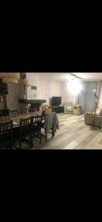 un salon avec une table, des chaises et un canapé dans l'établissement Maison entière, au Mans