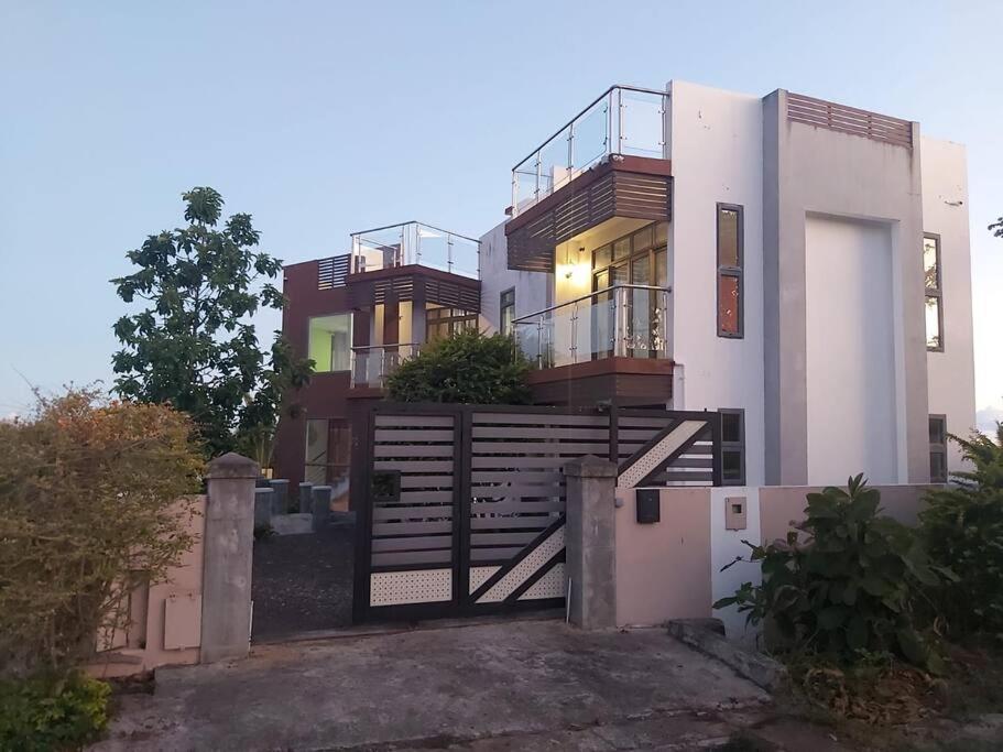 a building with a staircase in front of it at Serenity Cove - A Home Away From Home in Bel Ombre