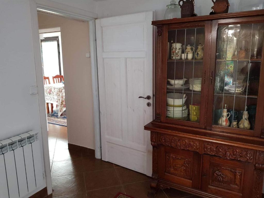 a room with a wooden hutch with dishes in it at Willa Różana in Rymanów-Zdrój