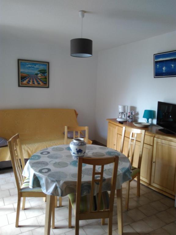 une cuisine avec une table, des chaises, une table et une table. dans l'établissement T2/T3 à sanary sur mer avec piscine, à Sanary-sur-Mer