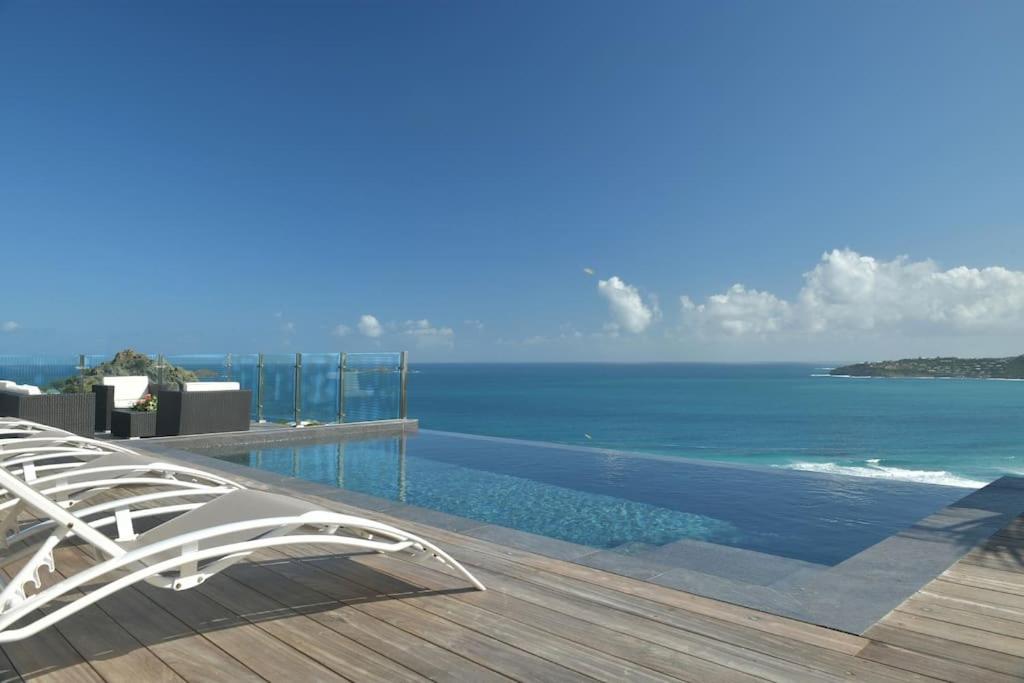 a swimming pool with a view of the ocean at The Red Cloud 3 in Saint Barthelemy