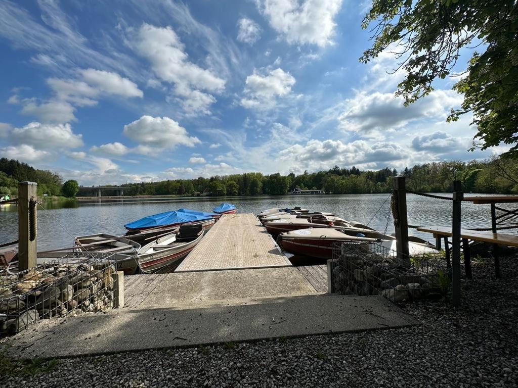 a group of boats docked at a dock on a lake at MemmingenBuxheimKartause in Buxheim
