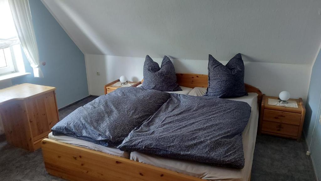 a bedroom with a bed with two pillows on it at Hühnerhof-Röhrs in Schneverdingen