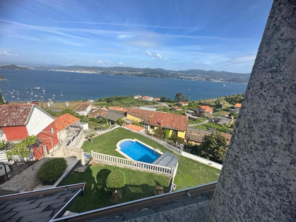 an aerial view of a house with a swimming pool at O Castro Sanxenxo in Sanxenxo