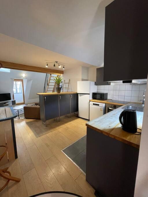 a kitchen with a counter top in a room at Loft 60 m2, Le Vieux-Mans in Le Mans