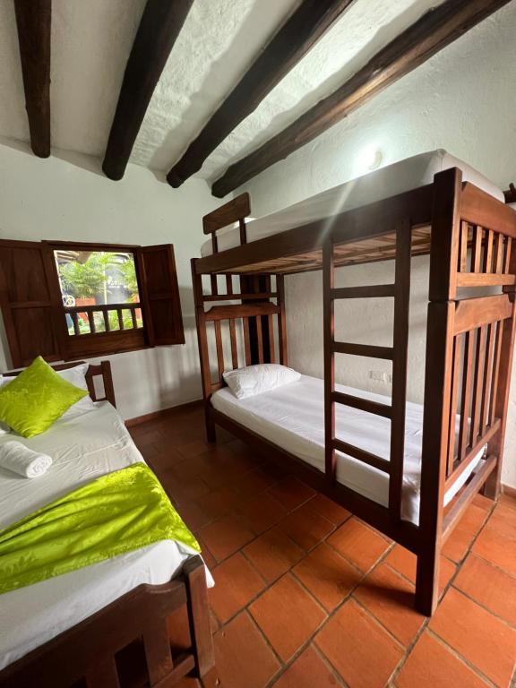 Postel nebo postele na pokoji v ubytování Hostal Villa San Rafael