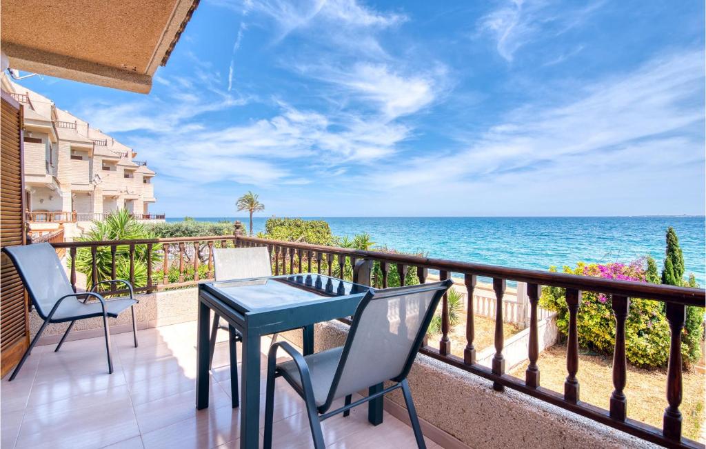 a balcony with a table and chairs and the ocean at Lovely Home In Santa Pola De Lest With House Sea View in Gran Alacant