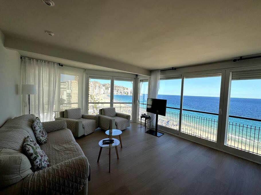 a living room with a view of the ocean at Primera Linea Playa de LEVANTE in Benidorm