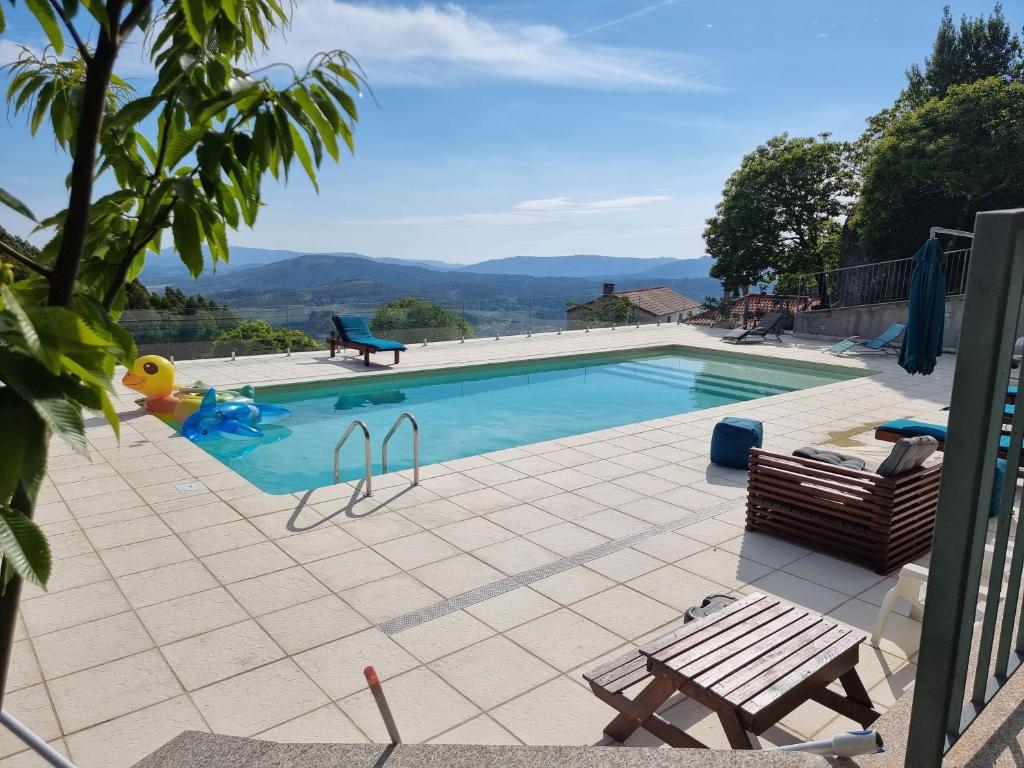 a swimming pool with a playground at Casa de Férias V6 com piscina in Ponte de Lima