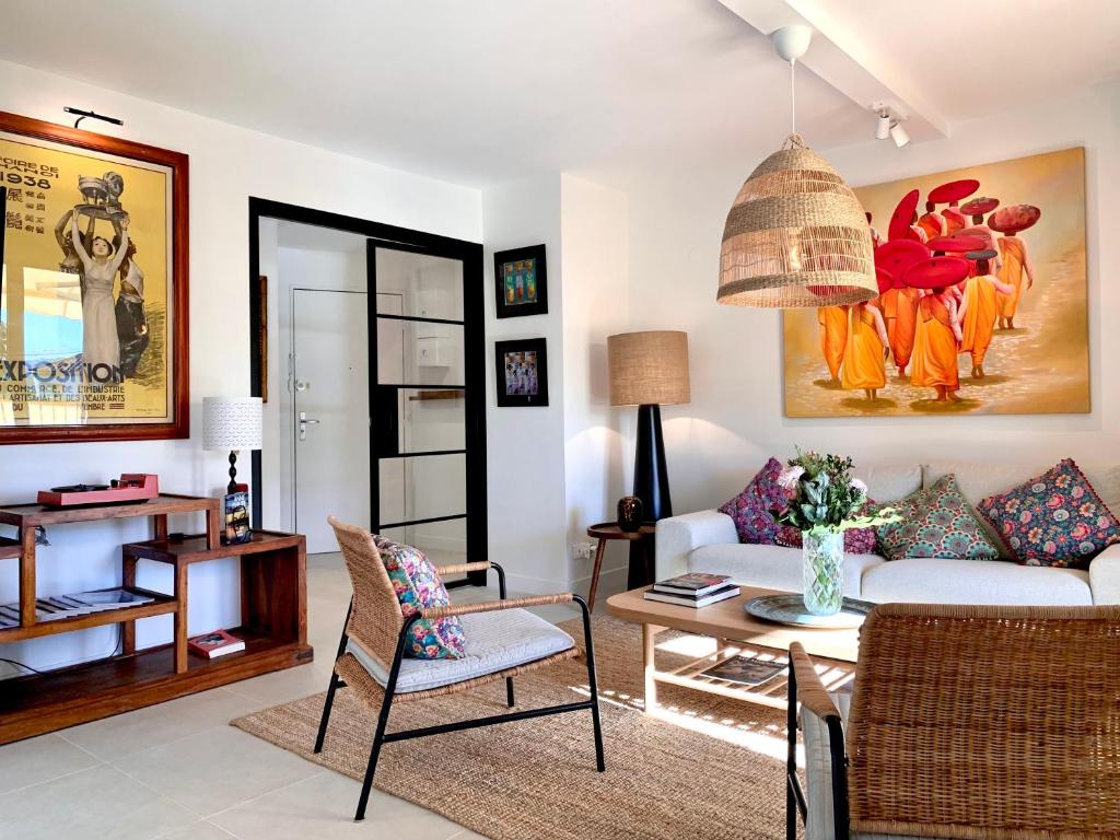 a living room with a couch and a table at Luxury Apartment St-Tropez/ 10mn walk to center. in Saint-Tropez