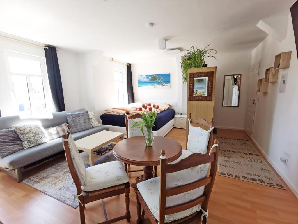 a living room with a table and a couch at Musashi Apartment 3 in Weimar