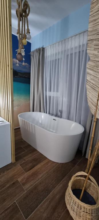 a bathroom with a white tub in a room at 107 Dreams in Tirana