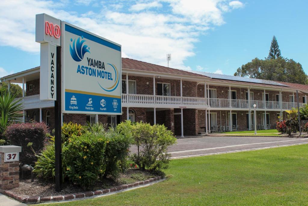 a building with a sign in front of it at Aston Motel Yamba in Yamba
