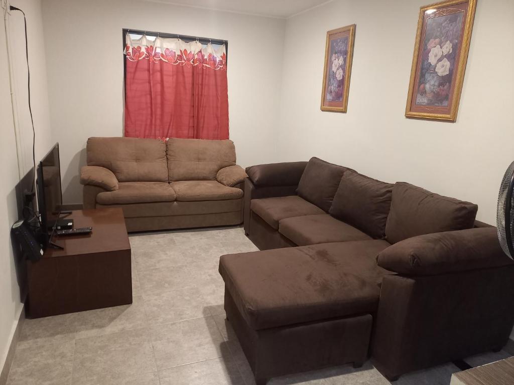a living room with a couch and a chair at Casa Blanca in Reynosa