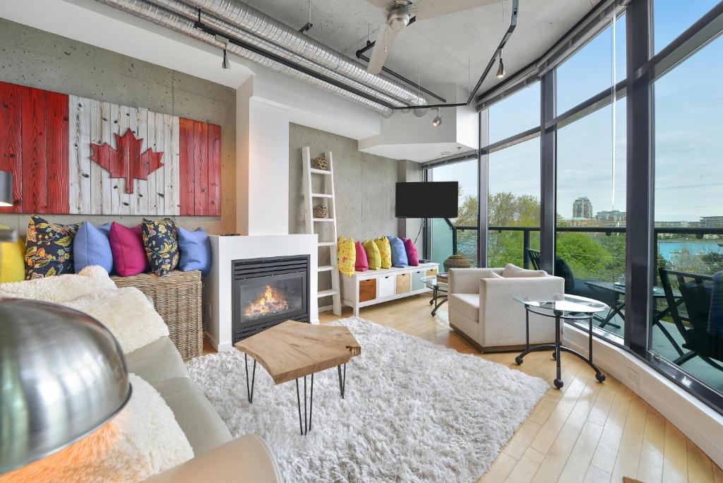 a living room with a couch and a fireplace at Harbourview Executive Condo in Victoria