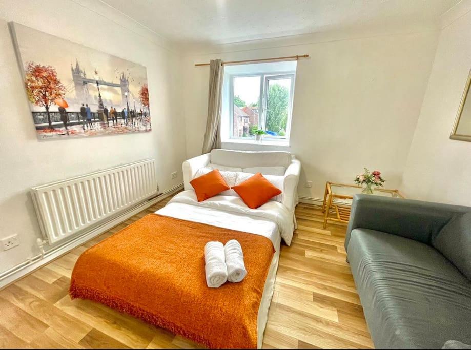 a small bedroom with a bed and a couch at Privite 2 bedrooms flat Canada Water in London