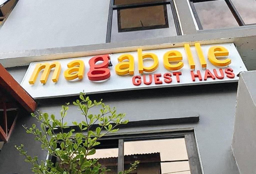 a sign for a mcdonalds restaurant on the side of a building at Magabelle Guesthouse in Cebu City