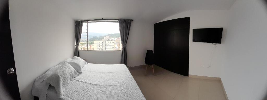 Postel nebo postele na pokoji v ubytování Casa Colibrí Hospedaje Manizales a 2 min del Cable y 1 min Zona G