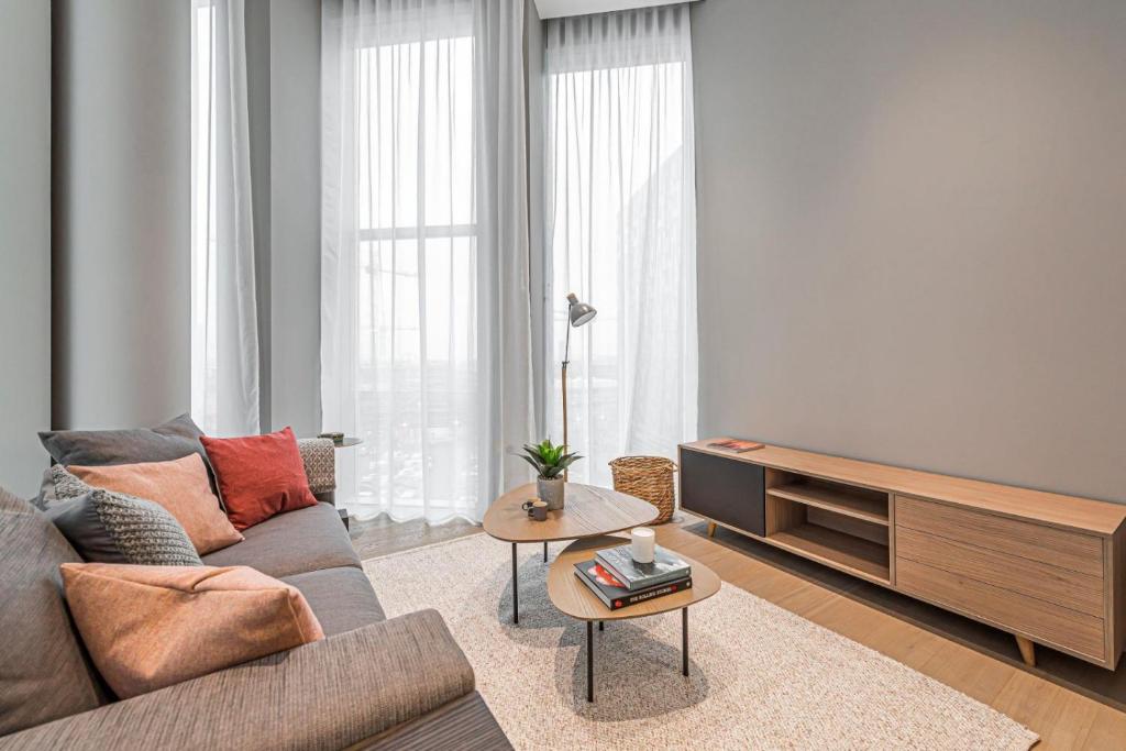 a living room with a couch and a table at The Cut- Stylish Riverside family home in London