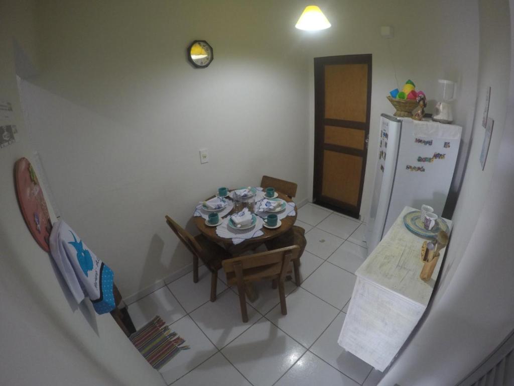 una pequeña cocina con mesa y nevera en Casas Maragogi 1, en Maragogi