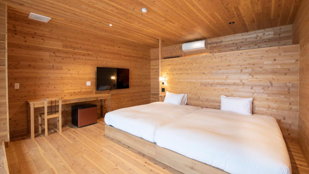 Postel nebo postele na pokoji v ubytování Genkai Ryokan