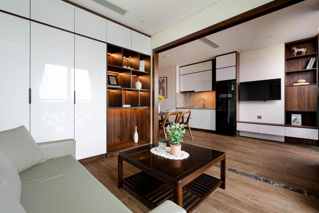 a living room with a couch and a table at MK Riverside Apartment by Haviland in Danang