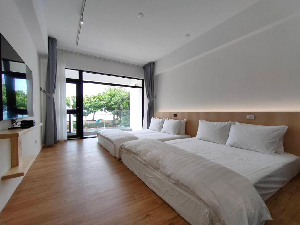Rúm í herbergi á Kenting Onehome